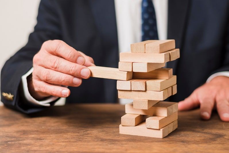 Business person playing Jenga