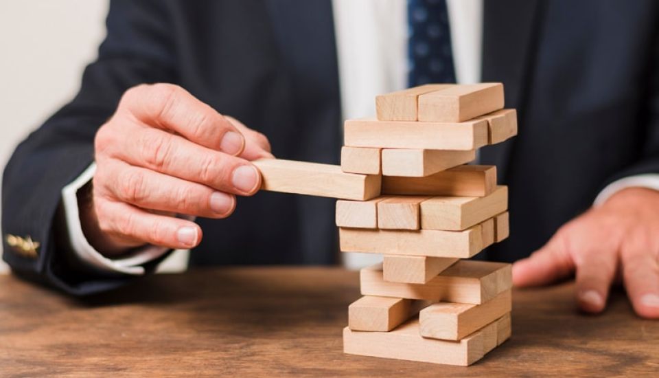 Business person playing Jenga