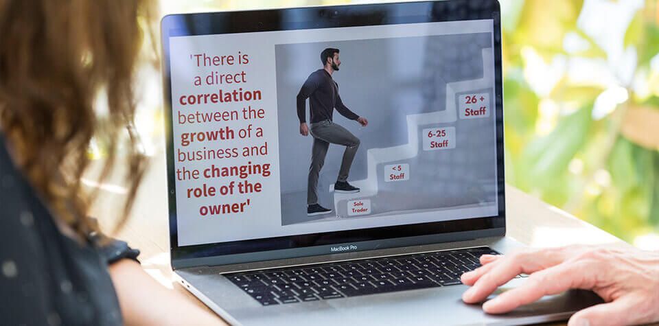 A laptop showing an image of a man walking on steps