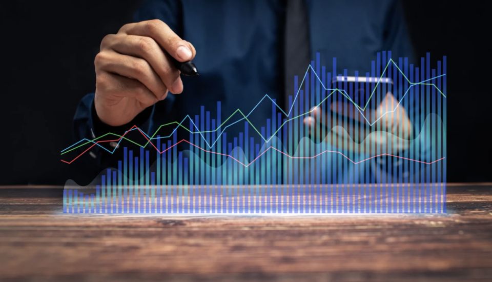 Business persons hand behind graph