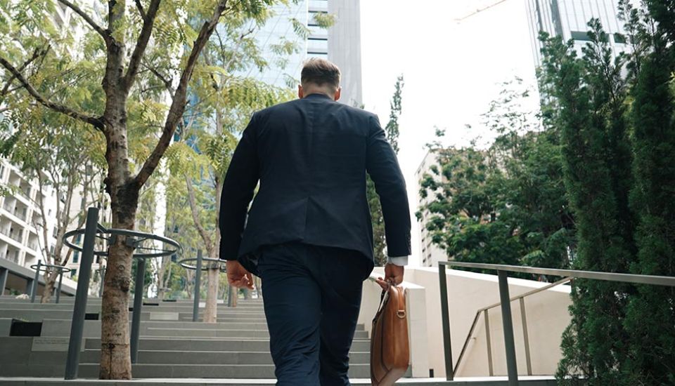 skilled manager walking up stairs